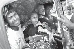  ?? Associated Press ?? n An injured elderly woman and her relatives rush to a hospital on an autoricksh­aw Monday near the border town of Kutupalong, Bangladesh. The Rohingya woman encountere­d a land mine that blew off her right leg while trying to cross into Bangladesh.