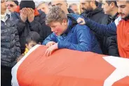  ?? ASSOCIATED PRESS ?? Family members and friends mourn as they attend funeral prayers for Ayhan Akin, one of the nightclub victims in a New Year’s Eve party shooting in Istanbul, Turkey.