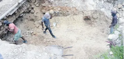  ?? JIS ?? Workers undertake repairs to a bridge in Seville Heights, St Ann.