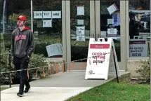  ?? BING GUAN / REUTERS ?? A University of Wisconsin- Madison student exits an on- campus COVID- 19 testing site on Oct 19, as coronaviru­s continues to rage in the United States.