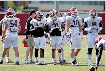  ??  ?? Linebacker depth has been an issue for the Arkansas Razorbacks in previous seasons, but Bumper Pool (second from right) said there’s reason to be optimistic about the position this season. “I think we’re going to surprise people,” Pool said. “I think we’ve got a good group and we have guys that are just young but they have the talent.”