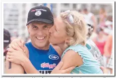  ?? Picture: GEOFF MCLACHLAN ?? Dean Mercer gets kiss of congratula­tions from ironwoman wife Reen Corbett after a win in 2003.