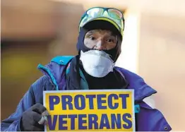  ?? JULIO CORTEZ AP ?? Army veteran Clarence Shields and a group of activists protest shortages of workers and protective equipment outside the Baltimore VA Medical Center.