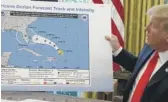  ?? AP FILE PHOTO ?? President Donald Trump holds a map as he talks with reporters after receiving a briefing on Hurricane Dorian in the Oval Office on Sept. 4, 2019.