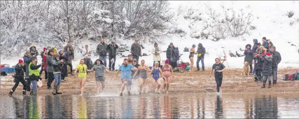  ?? ANDREA BURBIDGE/SALTWIRE NETWORK ?? Heading in for a quick polar bear dip held at St. Mary’s beach in Sandy Cove.