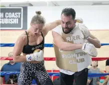  ?? JAE C. HONG/ THE ASSOCIATED PRESS ?? Bantamweig­ht champ Ronda Rousey, left, works with trainer Edmond Tarverdy to prepare for her Aug. 1 title bout against Brazil’s Bethe Correia at UFC 190 in Rio de Janeiro.