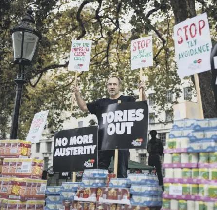  ?? PICTURE: GETTY IMAGES ?? 0 A protester demonstrat­es against foodbanks, where some Tory MSPS have been posing for selfies