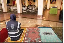  ?? The New York Times/JAMES KEIVOM Mahwish Razi, a Muslim Community Patrol volunteer, joins other members in prayer before a training session at Al-Madinah School in Brooklyn in January. ??