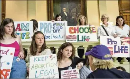  ?? AJC 2019 ?? Demonstrat­ors on both sides of the abortion issue display their signs. New statistics show medical school graduates in the U.S. are choosing to do their residencie­s in states with access to abortions and, by extension, abortion training. That means medical residencie­s in Georgia, a state with doctor shortages, are declining.