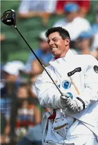  ??  ?? Driving into space: Rory McIlroy watching his tee shot on the driving range after becoming an astronaut for an advertisem­ent at Quail Hollow Club on Monday. — AP