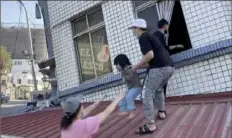  ?? TVBS via AP ?? Residents rescue a child from a partially collapsed building in Hualien, eastern Taiwan, on Wednesday.