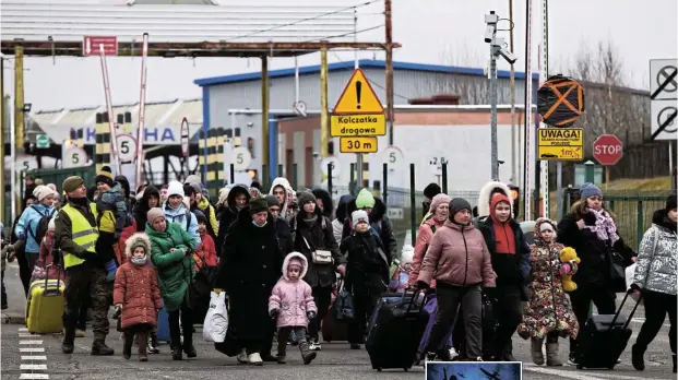  ?? Picture: Reuters ?? People from Ukraine fleeing Russia’s invasion of the country arrive in Poland after crossing the Polish-Ukrainian border checkpoint at Korczowa-Krakovets.