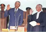  ?? ASSOCIATED PRESS ?? Nelson Mandela takes the oath of office to become South Africa’s first black president in 1994.