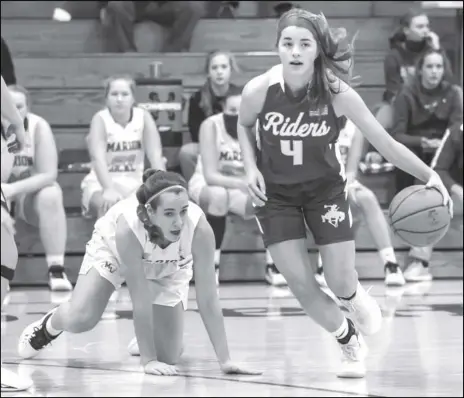  ?? Staff photo/David Pence ?? St. Marys’ Elena Menker (4) runs away from Marion Local’s Heidi Rethman during a non-league girls basketball game against Marion Local on Tuesday.