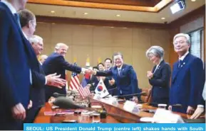  ??  ?? SEOUL: US President Donald Trump (centre left) shakes hands with South Korea’s President Moon Jae-In during a bilateral meeting at the presidenti­al Blue House yesterday.— AFP