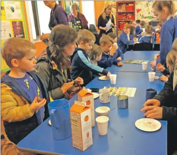  ??  ?? Shiskine Primary pupils tuck in to Fairtrade products during their Fairtrade coffee morning.