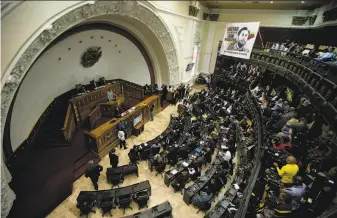  ?? Fernando Llano / Associated Press ?? Lawmakers attend a session at the opposition-controlled National Assembly to debate actions against President Nicolas Maduro. A resolution passed, accusing Maduro of “usurping” power.