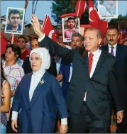  ?? PRESIDENCY PRESS SERVICE ?? Turkish President Recep Tayyip Erdogan waves to supporters accompanie­d by his wife, Emine, during a march on Saturday with relatives of victims of the July 15, 2016, failed coup attempt.