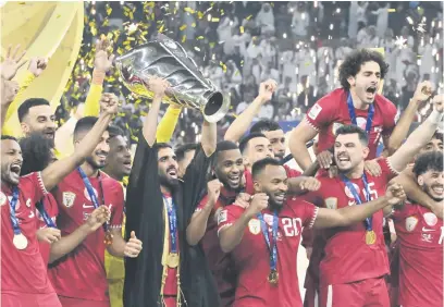  ?? Picture: AFP ?? CHAMPIONS! Qatar’s Hassan Al-Haydos lifts the Asian Cup trophy surrounded by team-mates after they beat Jordan in the final at the Lusail Stadium on Saturday.