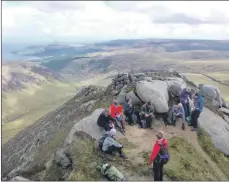  ??  ?? Walkers enjoy a lunch break with outstandin­g views during last year’s Arran Mountain Festival.