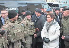  ?? EUROPEAN PRESS AGENCY ?? Polish Prime Minister Beata Szydlo (second from right) and Polish Gen. Jaroslaw Mika (right) greet members of the U.S. Army on Saturday in Zagan, Poland.