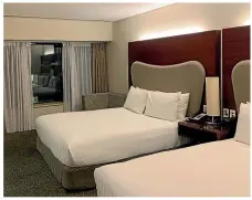  ??  ?? The room within the Crowne Plaza Auckland facility had two queensized beds, a desk, a lounge, and a kettle and bar fridge.