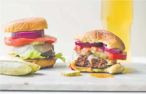  ??  ?? Deviled Burgers get their kick from a mix of fresh herbs, spices and hot sauce.