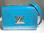  ??  ?? LV Twist in Bleu Canard croc skin: It is lined with luxurious goatskin and features the distinctiv­e Capucines flap.