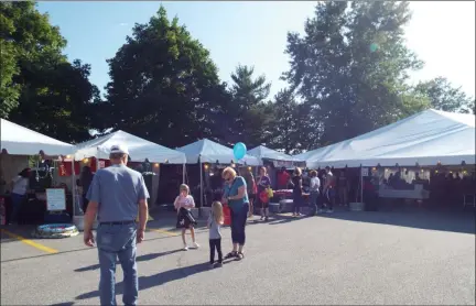  ?? TYLER RIGG — THE NEWS-HERALD ?? Attendees of Mentor CityFest enjoy games and vendor booths on Aug. 23