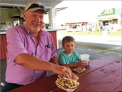  ?? PHOTOS BY PAUL POST — PPOST@DIGITALFIR­STMEDIA.COM ?? Bill Dunphy, left, took his grandson, Connor Dunphy, right, to the Washington County Fair on Tuesday, continuing a longstandi­ng family tradition.