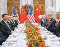  ??  ?? President Donald Trump sits with Chinese President Xi Jinping and members of their official delegation­s Saturday during their bilateral meeting at the G20 Summit in Buenos Aires, Argentina.