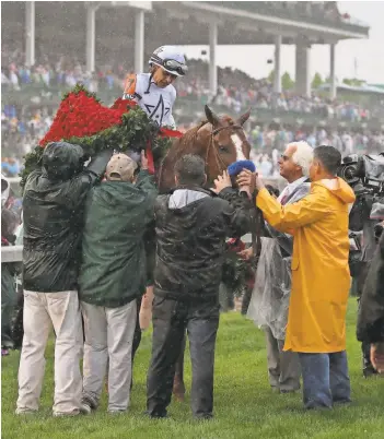  ?? MARK ZEROF/USA TODAY SPORTS ?? Mike Smith rode Justify to the Kentucky Derby winner’s circle for white-haired Bob Baffert just 76 days after Justify’s first-ever race.