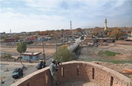  ?? ZAKERIA HASHIMI/AFP/GETTY IMAGES ?? An Afghan security officer keeps watch in Ghazni, where three Americans died Tuesday.