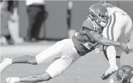  ?? ROGELIO V. SOLIS/AP ?? Mississipp­i defensive back Deane Leonard, left, tackles Arkansas running back Raheim Sanders during Saturday’s game in Oxford, Miss.