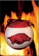  ?? Arkansas Democrat-Gazette/JOHN SYKES JR. ?? The Arkansas Razorback carries the ball all the way to a touchdown on the tree, thanks to this ornament, among this year’s many Hog-theme Christmas decoration­s.