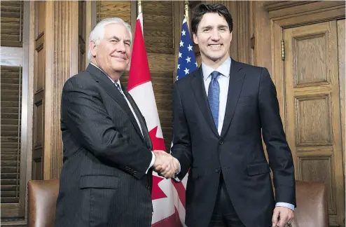  ?? ADRIAN WYLD / AFP POOL / GETTY IMAGES ?? U. S. Secretary of State Rex Tillerson and Prime Minister Justin Trudeau shake at the start of a meeting in Ottawa.