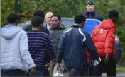  ?? (Photo AFP) ?? Après un passage par un centre d’enregistre­ment et un long voyage en bus depuis l’Italie, ces dix-huit hommes et une femme ont débarqué à Vertou.