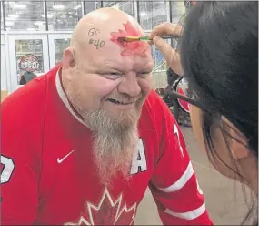  ?? PHOTO BY KEVIN ADSHADE ?? Gerard Halfyard of Trenton had some artwork done at the Pictou County Wellness Centre on Wednesday, Feb. 14, as he and close to 200 others gathered to watch Stellarton’s Blayre Turnbull play for Team Canada’s female hockey team at the 2018 Winter Olympic Games.