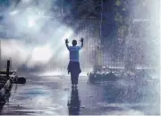  ?? MUJAHID SAFODIEN/ASSOCIATED PRESS ?? An opposition MDC party supporter holds his hands up after being sprayed with a water cannon on a street in Harare, during clashes with police Wednesday.