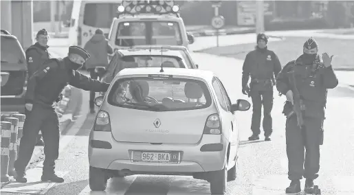  ?? LAURENT DUBRULE, EUROPEAN PRESSPHOTO AGENCY ?? Police forces check vehicles at the entry to the Brussels Airport on Tuesday.