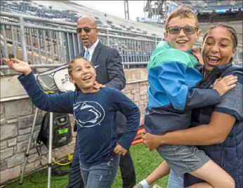  ?? Steph Chambers/Post-Gazette ?? James Franklin, daughters Addison, left, Shola, right, and one of their friends check out Beaver Stadium last September in the hours before the Pitt-Penn State game in University Park, Pa.