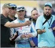  ?? JOHN RAOUX — THE ASSOCIATED PRESS ?? Fans takes selfie photos with Kevin Harvick, center, in the garage area during a practice session for the NASCAR Daytona 500auto race at Daytona Internatio­nal Speedway on Friday in Daytona Beach, Fla.