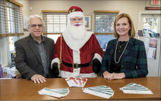  ?? Photo by Michael Derr ?? Joe Viele and Laurie McCoy, of the Southern Rhode Island Chamber of Commerce, are pictured with the chamber’s gift certificat­es on Monday morning.