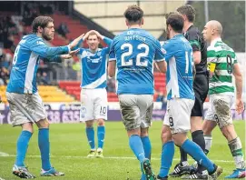  ?? Picture: SNS Group. ?? Saints players are left stunned as referee Craig Thomson awards Celtic a controvers­ial penalty in the champions’ 5-2 victory at McDiarmid Park in February.