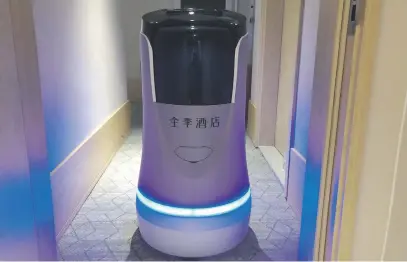  ?? Picture: AFP ?? ROOM SERVICE. A robot capable of taking lifts and navigating hallways on its own delivers food to a guest at a quarantine hotel housing people from Hubei province in Beijing.