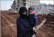  ?? HUSSEIN MALLA — THE ASSOCIATED PRESS ?? Ayesha, who lost her home in the devastatin­g earthquake, carries her granddaugh­ter in Atareb, Syria, on Sunday.