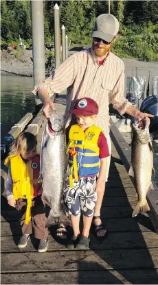  ??  ?? Kevin Maier brings in the day’s catch at the North Douglas boat launch in Juneau, Alaska with his sons Reed, right, and Henry in June 2013.