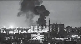  ??  ?? An explosion is seen in Gaza City after an airstrike. (Photo: The Times of Israel)