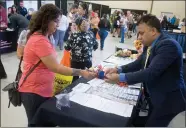  ??  ?? Attendees of the 2018 Business Expo were given a ‘passport’ which they could get signed off by the 40 local business booths for a chance to win big prizes Thursday, Oct. 11, at the 2018 Business Expo at the Portervill­e Fairground­s.