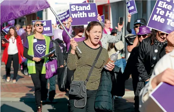  ?? SCOTT HAMMOND/STUFF ?? Over 50 nurses marched through Blenheim’s CBD, demanding fair pay and better staffing.